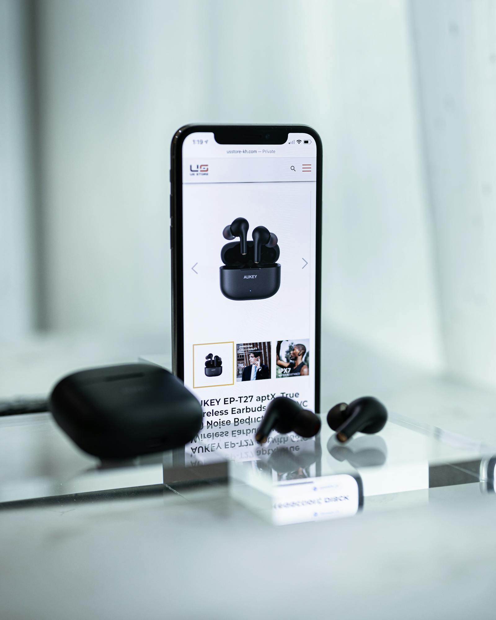 Wireless earbuds and a smartphone used as article artwork.