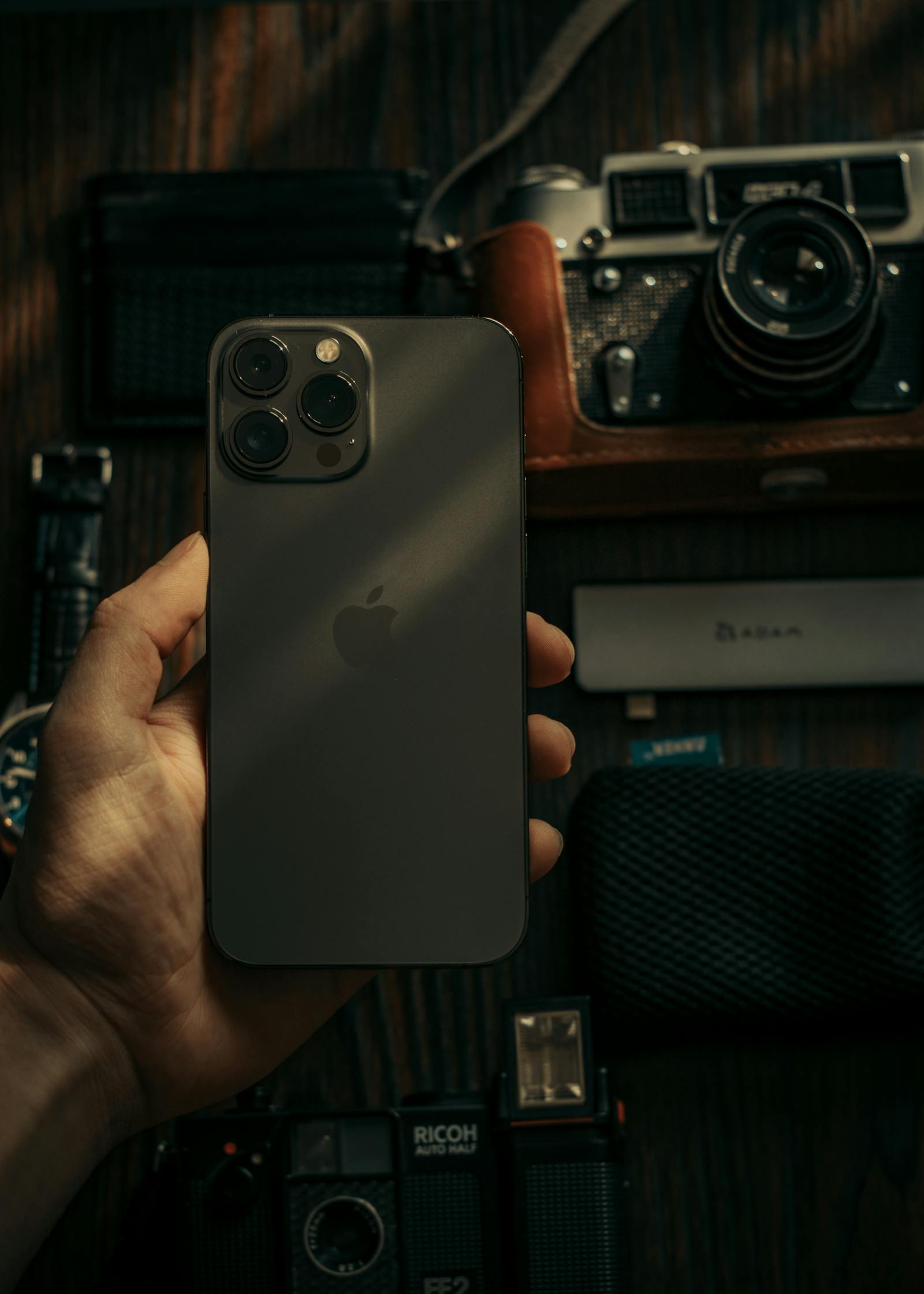 Hand holding a smartphone used as article artwork.